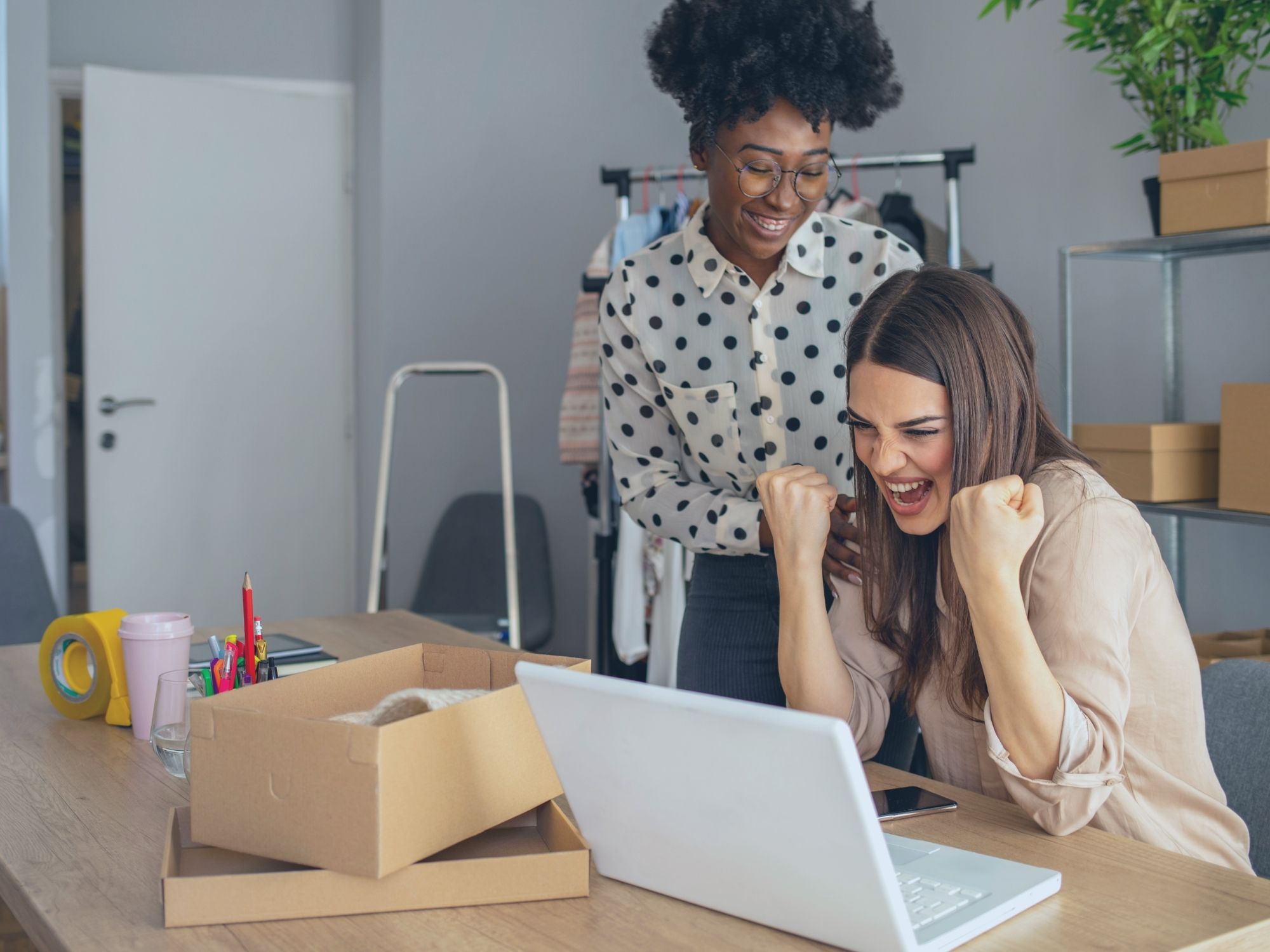 business happy owner seeing online sales on laptop