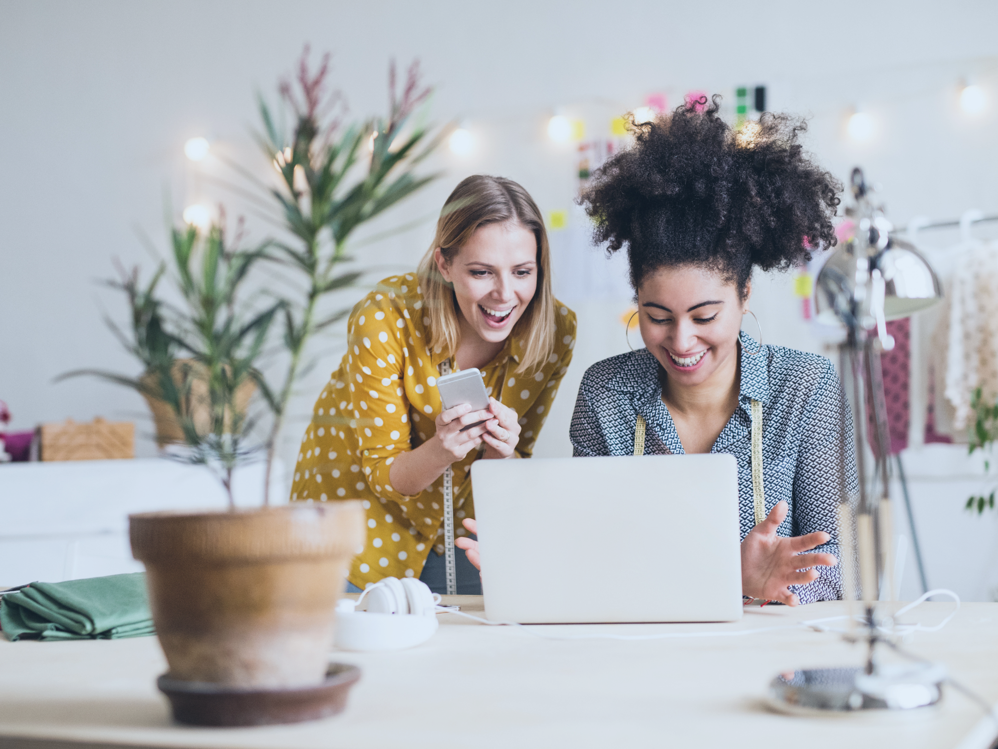 two business women looking at laptop screen